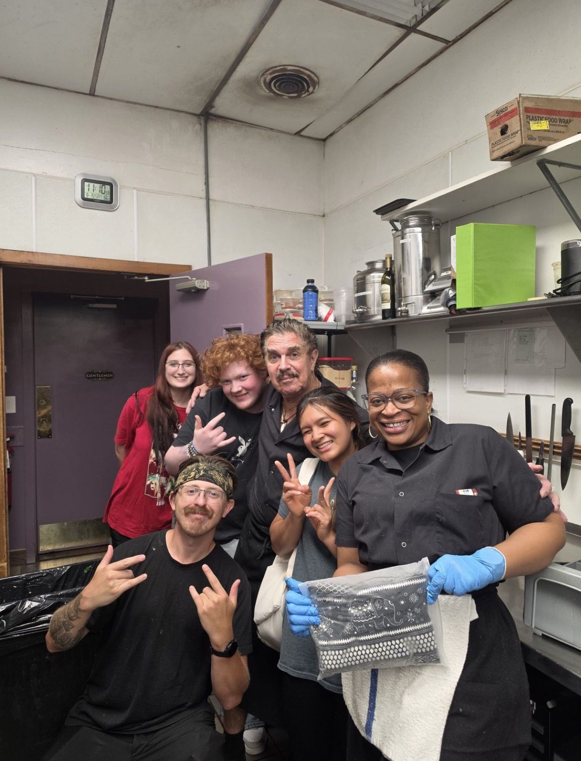 Six members of the Amical kitchen and dish crew posing in the dish room
